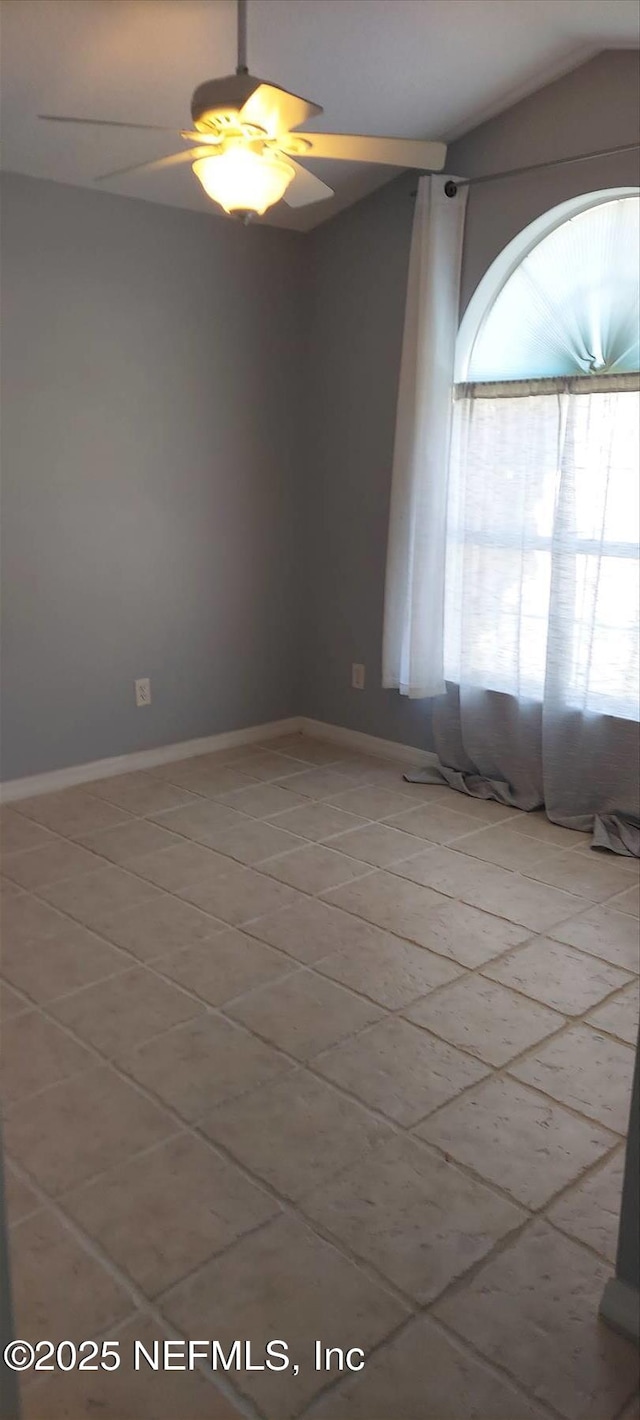 2340 Commodores Club Blvd, Saint Augustine, FL 32080 - spare room with light tile patterned flooring, a ceiling fan, baseboards, and lofted ceiling