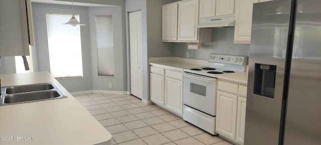 2340 Commodores Club Blvd, Saint Augustine, FL 32080 - kitchen with stainless steel fridge, white electric range, under cabinet range hood, light countertops, and light tile patterned floors