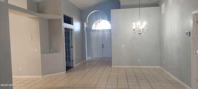 2340 Commodores Club Blvd, Saint Augustine, FL 32080 - foyer with a chandelier, light tile patterned flooring, and baseboards
