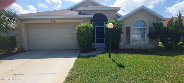 2340 Commodores Club Blvd, Saint Augustine, FL 32080 - view of front of home with stucco siding, driveway, a garage, and a front lawn