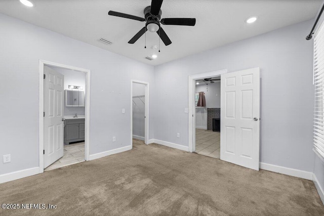 4537 Springfield Blvd, Jacksonville, FL 32206 - unfurnished bedroom with a walk in closet, light carpet, ensuite bathroom, a sink, and recessed lighting