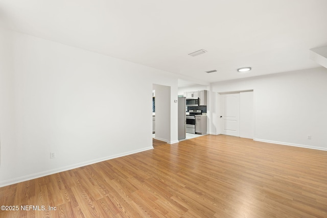1927 Lakewood Cir N, Jacksonville, FL 32207 - unfurnished living room featuring light wood-style flooring and baseboards