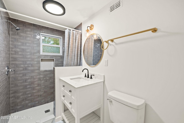 1927 Lakewood Cir N, Jacksonville, FL 32207 - bathroom featuring vanity, a tile shower, and toilet