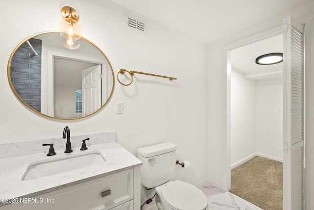 1927 Lakewood Cir N, Jacksonville, FL 32207 - bathroom featuring vanity, toilet, baseboards, and marble finish flooring