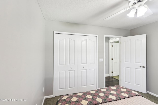 1708 Bridled Tern Ct, Fleming Island, FL 32003 - unfurnished bedroom featuring a closet, baseboards, dark colored carpet, ceiling fan, and a textured ceiling
