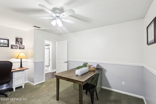 1708 Bridled Tern Ct, Fleming Island, FL 32003 - home office with a textured ceiling, ceiling fan, dark colored carpet, and baseboards