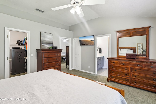 1708 Bridled Tern Ct, Fleming Island, FL 32003 - carpeted bedroom with vaulted ceiling, connected bathroom, a closet, a ceiling fan, and baseboards