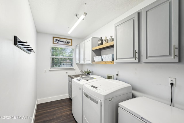 1708 Bridled Tern Ct, Fleming Island, FL 32003 - laundry room featuring cabinet space, separate washer and dryer, dark wood finished floors, and baseboards