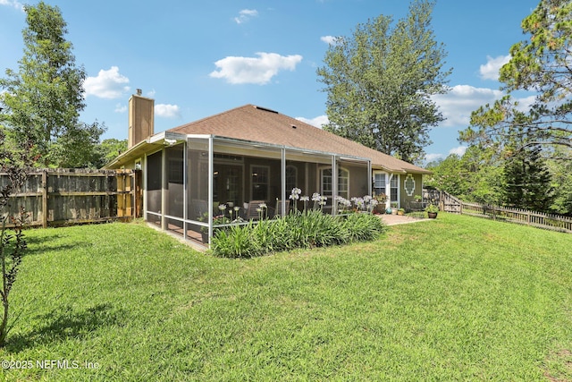 1708 Bridled Tern Ct, Fleming Island, FL 32003 - back of property with a chimney, a sunroom, and roof with shingles