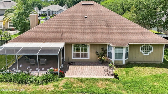 1708 Bridled Tern Ct, Fleming Island, FL 32003 - rear view of property featuring a shingled roof, a patio area, and a lawn