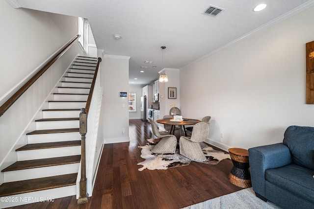 2189 2nd St S, Jacksonville Beach, FL 32250 - dining area featuring wood finished floors, stairs, crown molding, baseboards, and recessed lighting
