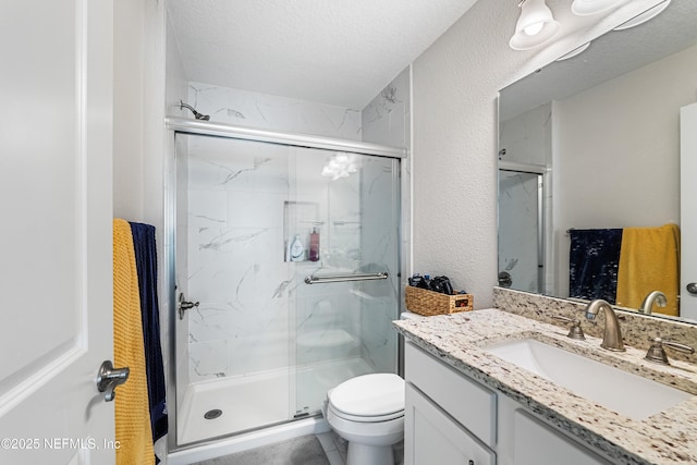 2189 2nd St S, Jacksonville Beach, FL 32250 - bathroom with vanity, a marble finish shower, toilet, and a textured wall