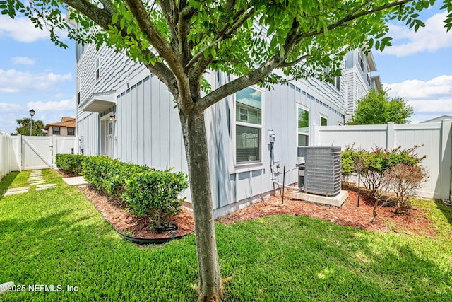 2189 2nd St S, Jacksonville Beach, FL 32250 - view of home's exterior with cooling unit, a gate, and board and batten siding