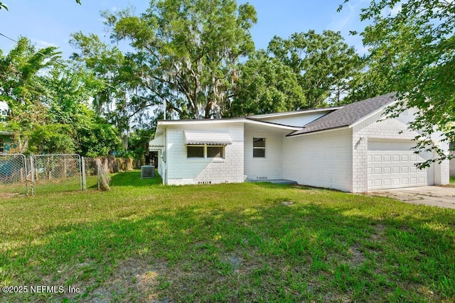 4249 Lockhart Dr, Jacksonville, FL 32209 - mid-century home with central AC, an attached garage, concrete driveway, and brick siding