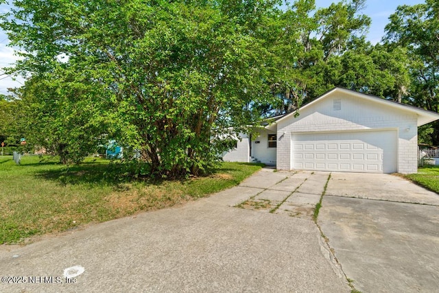 4249 Lockhart Dr, Jacksonville, FL 32209 - view of front of house with driveway, an attached garage, and a front lawn