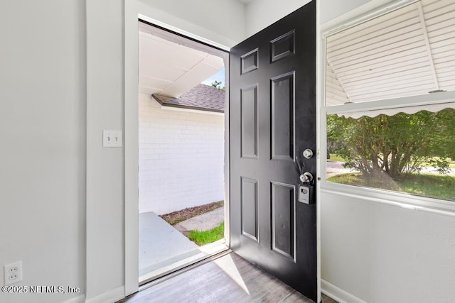 4249 Lockhart Dr, Jacksonville, FL 32209 - entrance foyer with healthy amount of natural light, wood finished floors, and baseboards