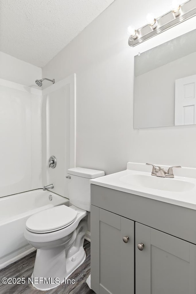 4249 Lockhart Dr, Jacksonville, FL 32209 - bathroom featuring vanity, wood finished floors, tub / shower combination, toilet, and a textured ceiling