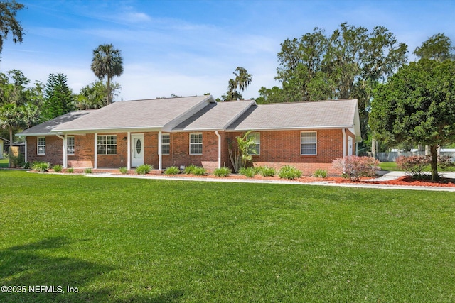 133 Divi Divi Dr, San Mateo, FL 32187 - ranch-style home with a front lawn and brick siding