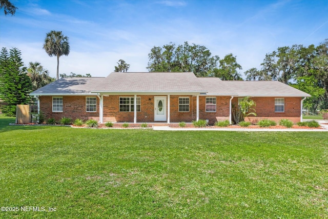 133 Divi Divi Dr, San Mateo, FL 32187 - ranch-style house featuring a front yard and brick siding
