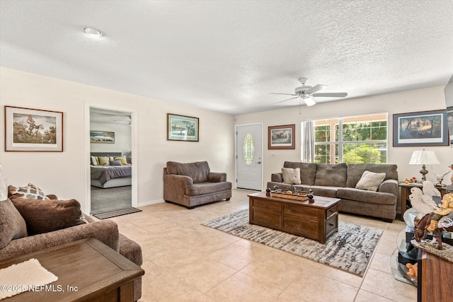 133 Divi Divi Dr, San Mateo, FL 32187 - living area featuring a ceiling fan, a textured ceiling, and light tile patterned flooring