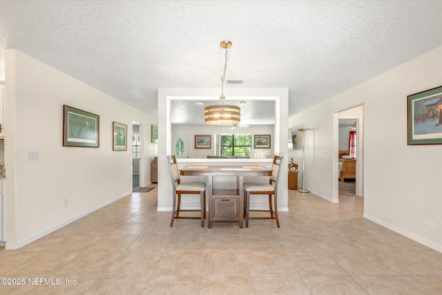 133 Divi Divi Dr, San Mateo, FL 32187 - dining room featuring a textured ceiling, light tile patterned flooring, and baseboards