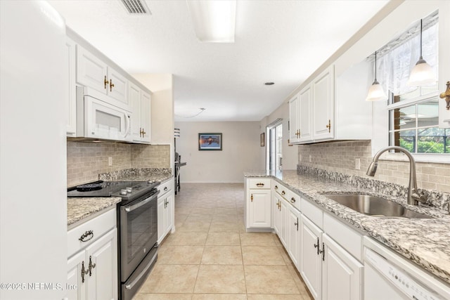 133 Divi Divi Dr, San Mateo, FL 32187 - kitchen featuring white appliances, a sink, white cabinets, and tasteful backsplash
