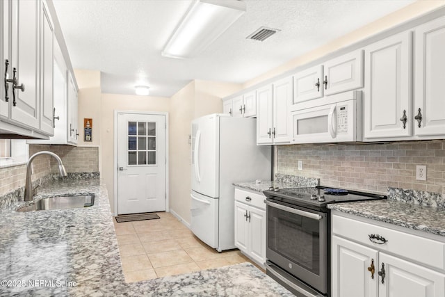 133 Divi Divi Dr, San Mateo, FL 32187 - kitchen with white appliances, a sink, white cabinetry, backsplash, and a textured ceiling