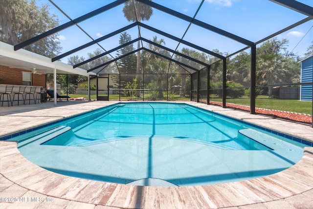 133 Divi Divi Dr, San Mateo, FL 32187 - outdoor pool with a patio area, glass enclosure, ceiling fan, and a yard
