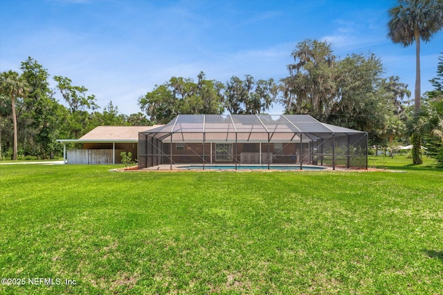 133 Divi Divi Dr, San Mateo, FL 32187 - rear view of house with a lawn, an outdoor pool, and a lanai