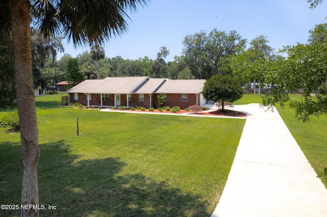 133 Divi Divi Dr, San Mateo, FL 32187 - single story home featuring driveway, a front lawn, and brick siding