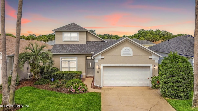 165 Cedar Ridge Cir, Saint Augustine, FL 32080 - traditional home featuring stucco siding, roof with shingles, driveway, and a garage