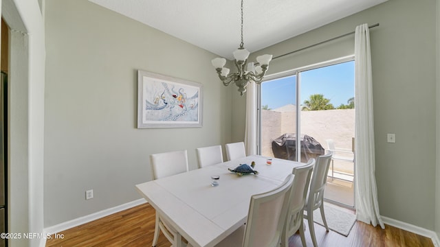 165 Cedar Ridge Cir, Saint Augustine, FL 32080 - dining space featuring a chandelier, baseboards, and wood finished floors