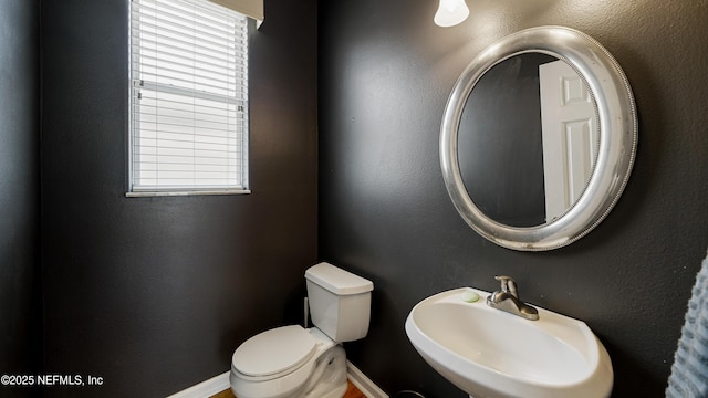 165 Cedar Ridge Cir, Saint Augustine, FL 32080 - bathroom featuring a sink, plenty of natural light, toilet, and baseboards