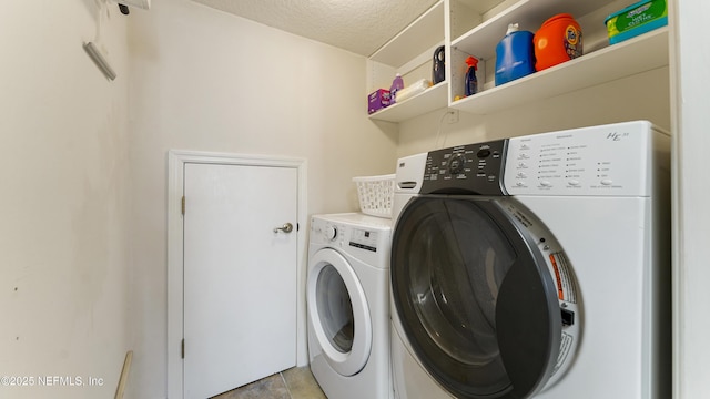 165 Cedar Ridge Cir, Saint Augustine, FL 32080 - laundry room with washer and clothes dryer and a textured ceiling