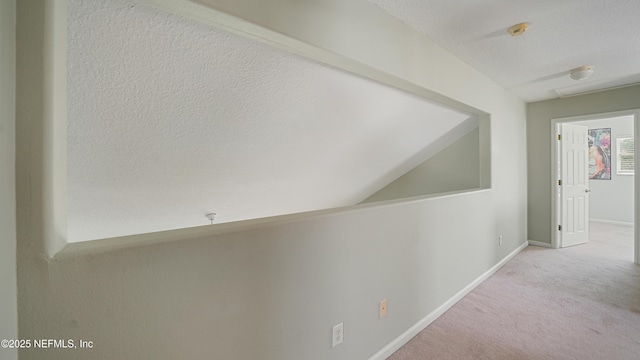 165 Cedar Ridge Cir, Saint Augustine, FL 32080 - hallway featuring carpet floors, baseboards, and a textured ceiling
