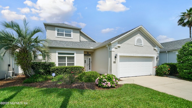 165 Cedar Ridge Cir, Saint Augustine, FL 32080 - traditional home featuring concrete driveway, stucco siding, an attached garage, a front lawn, and roof with shingles