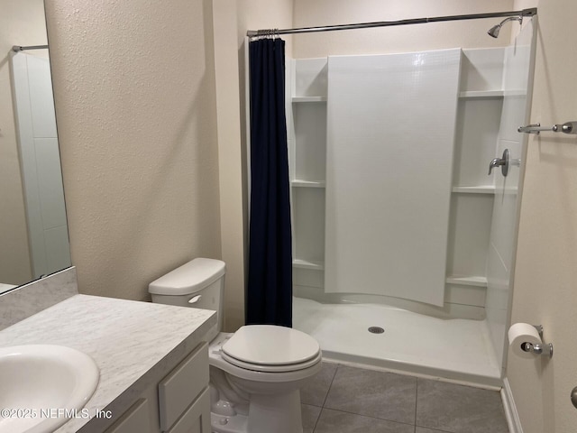 86768 Shortline Cir, Yulee, FL 32097 - bathroom with tile patterned flooring, a shower stall, vanity, toilet, and a textured wall