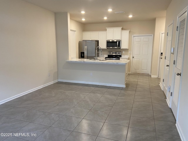86768 Shortline Cir, Yulee, FL 32097 - kitchen featuring appliances with stainless steel finishes, tile patterned flooring, white cabinetry, a peninsula, and recessed lighting
