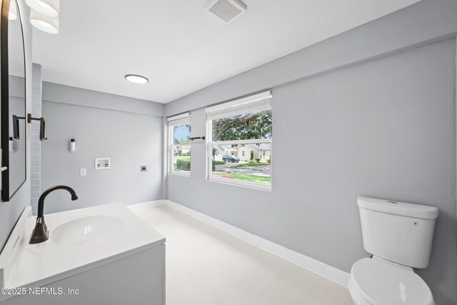 1470 River Hills Cir E, Jacksonville, FL 32211 - bathroom featuring toilet, vanity, and baseboards