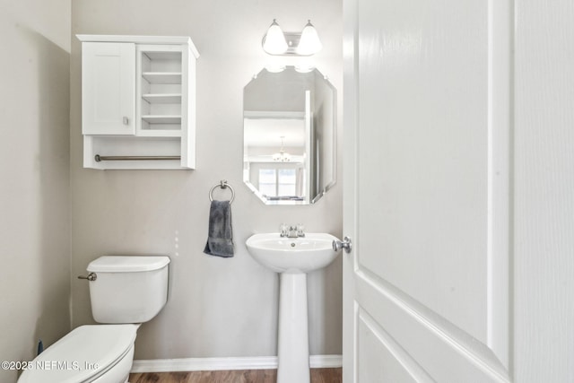 6033 Bartram Village Dr, Jacksonville, FL 32258 - half bath with toilet, wood finished floors, a sink, and baseboards