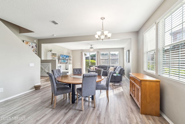 6033 Bartram Village Dr, Jacksonville, FL 32258 - dining room with light wood finished floors, a chandelier, baseboards, and a ceiling fan