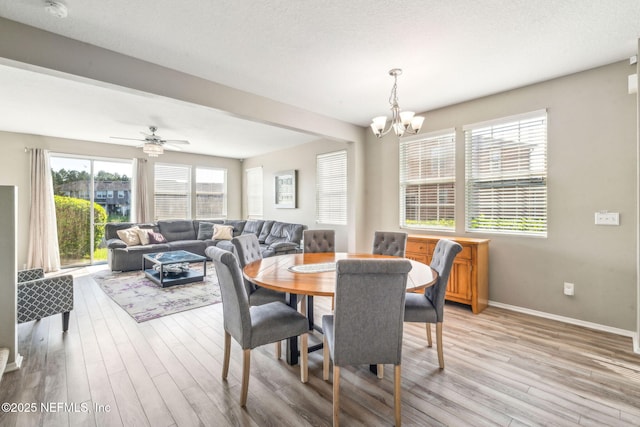 6033 Bartram Village Dr, Jacksonville, FL 32258 - dining space with light wood-style flooring, a chandelier, and baseboards