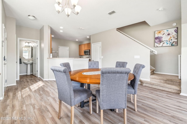 6033 Bartram Village Dr, Jacksonville, FL 32258 - dining space featuring light wood finished floors, stairs, baseboards, a chandelier, and recessed lighting