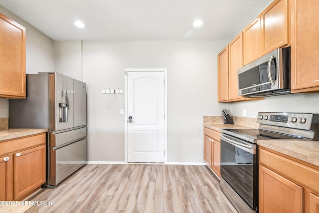 6033 Bartram Village Dr, Jacksonville, FL 32258 - kitchen featuring stainless steel appliances, light wood-type flooring, light countertops, baseboards, and recessed lighting