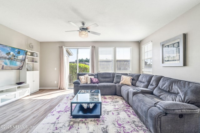 6033 Bartram Village Dr, Jacksonville, FL 32258 - living room featuring wood finished floors, a ceiling fan, and baseboards