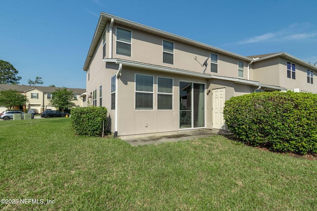 6033 Bartram Village Dr, Jacksonville, FL 32258 - back of house featuring a yard and stucco siding