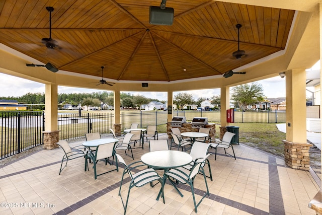 6033 Bartram Village Dr, Jacksonville, FL 32258 - view of patio featuring a gazebo, a ceiling fan, a water view, outdoor dining area, and an outdoor kitchen