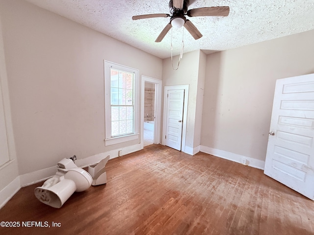 2771 Sunnyside St, Jacksonville, FL 32254 - unfurnished bedroom with a textured ceiling, wood finished floors, baseboards, and ceiling fan