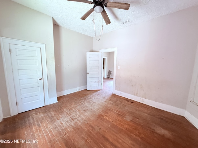 2771 Sunnyside St, Jacksonville, FL 32254 - spare room with a textured ceiling, ceiling fan, wood finished floors, and baseboards