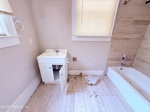 2771 Sunnyside St, Jacksonville, FL 32254 - full bath with vanity, wood finished floors, shower / washtub combination, and baseboards